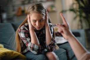 Mother scolding daughter. Girl afraid of her mother.