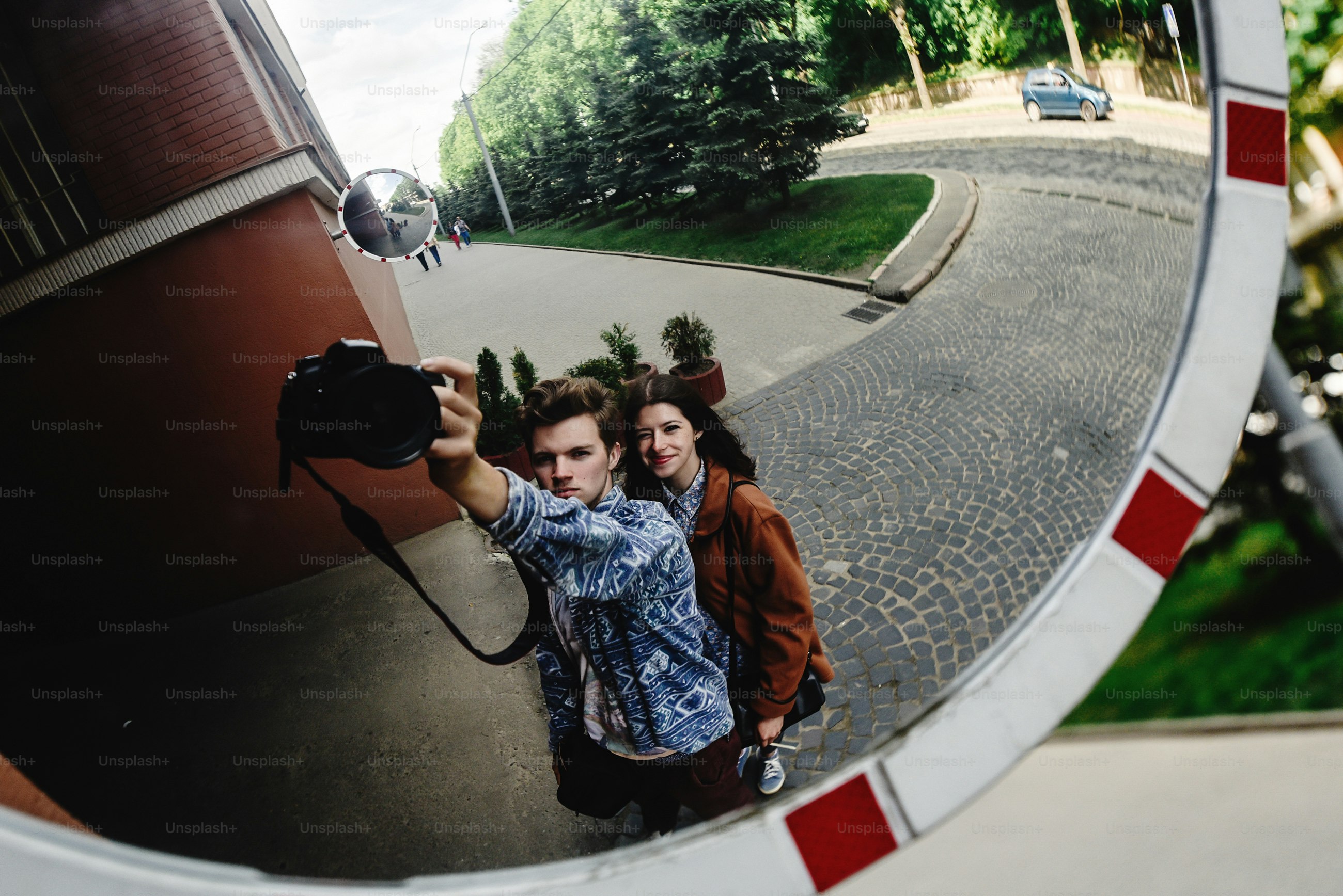 stylish happy hipster couple having fun laughing and taking selfies in the park in town in sunny spring time