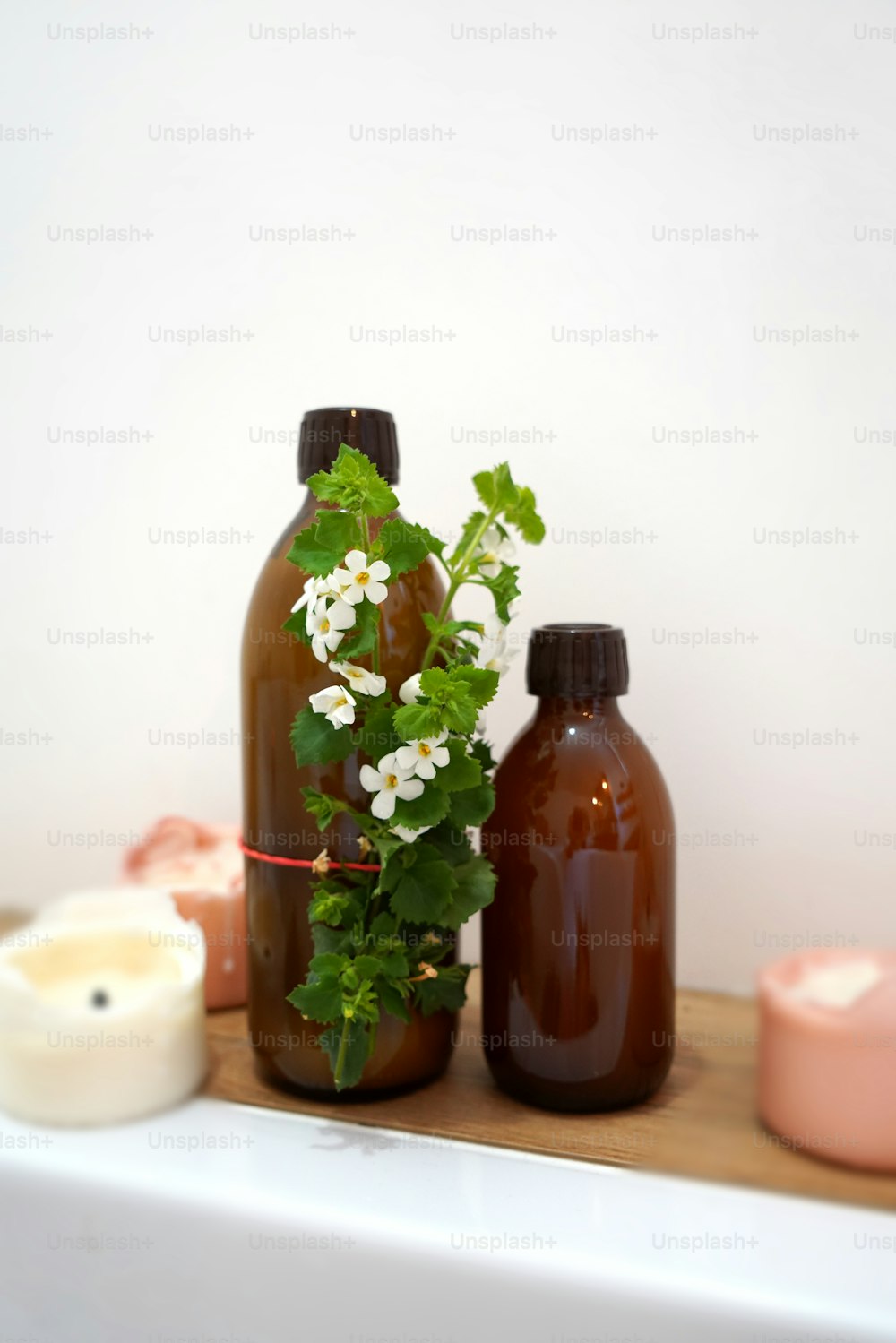 Glass bottles of soap and liquid in bathroom. Natural cosmetics. Spa and wellness.