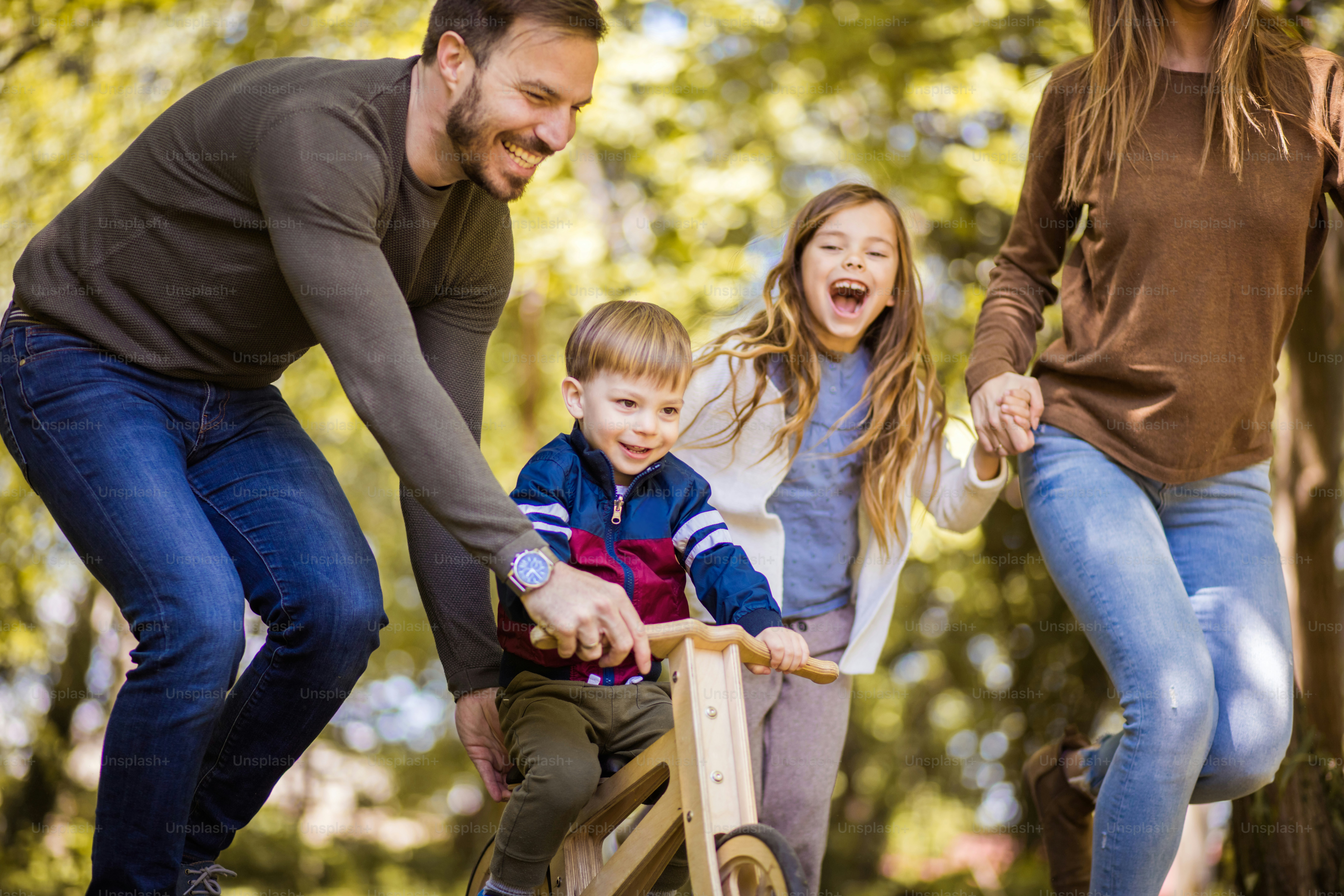 It is important to give your children pleasure and happiness through childhood. Parents spending time with their children outside. photo – Motion Image on Unsplash