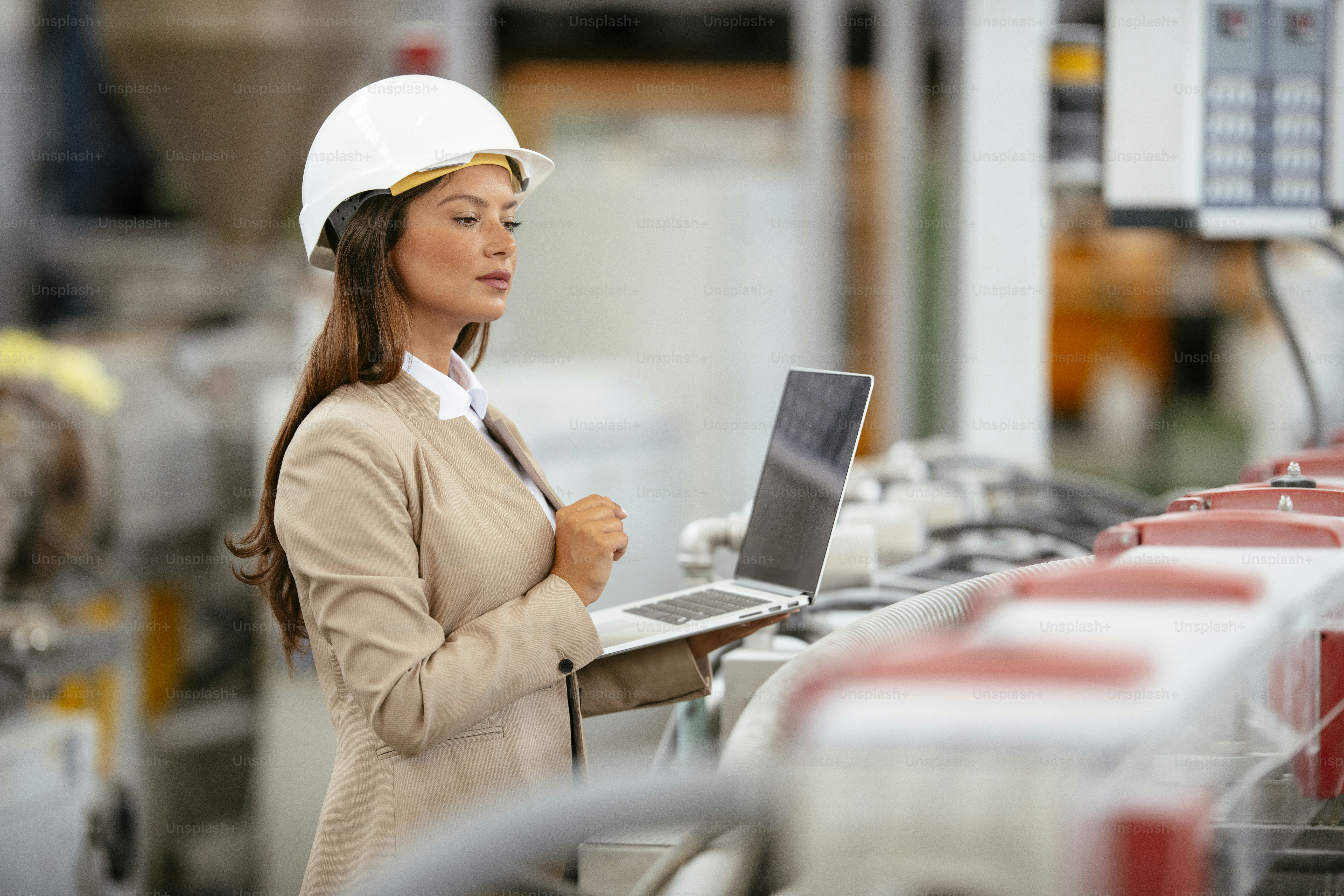 Factory manager in inspection of manufacturing. Businesswoman in Industrial Environment.