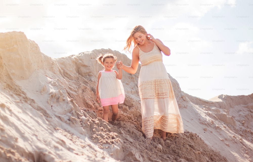 Mother and daughter in desert.