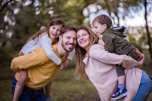 Being a family means being part of something very wonderful. Parents spending time with their children outside.