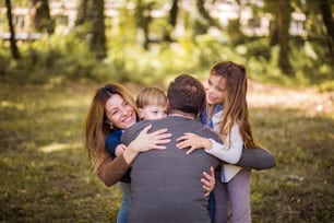 Taking precious bonding time out to the park. Parents spending time with their children outside.