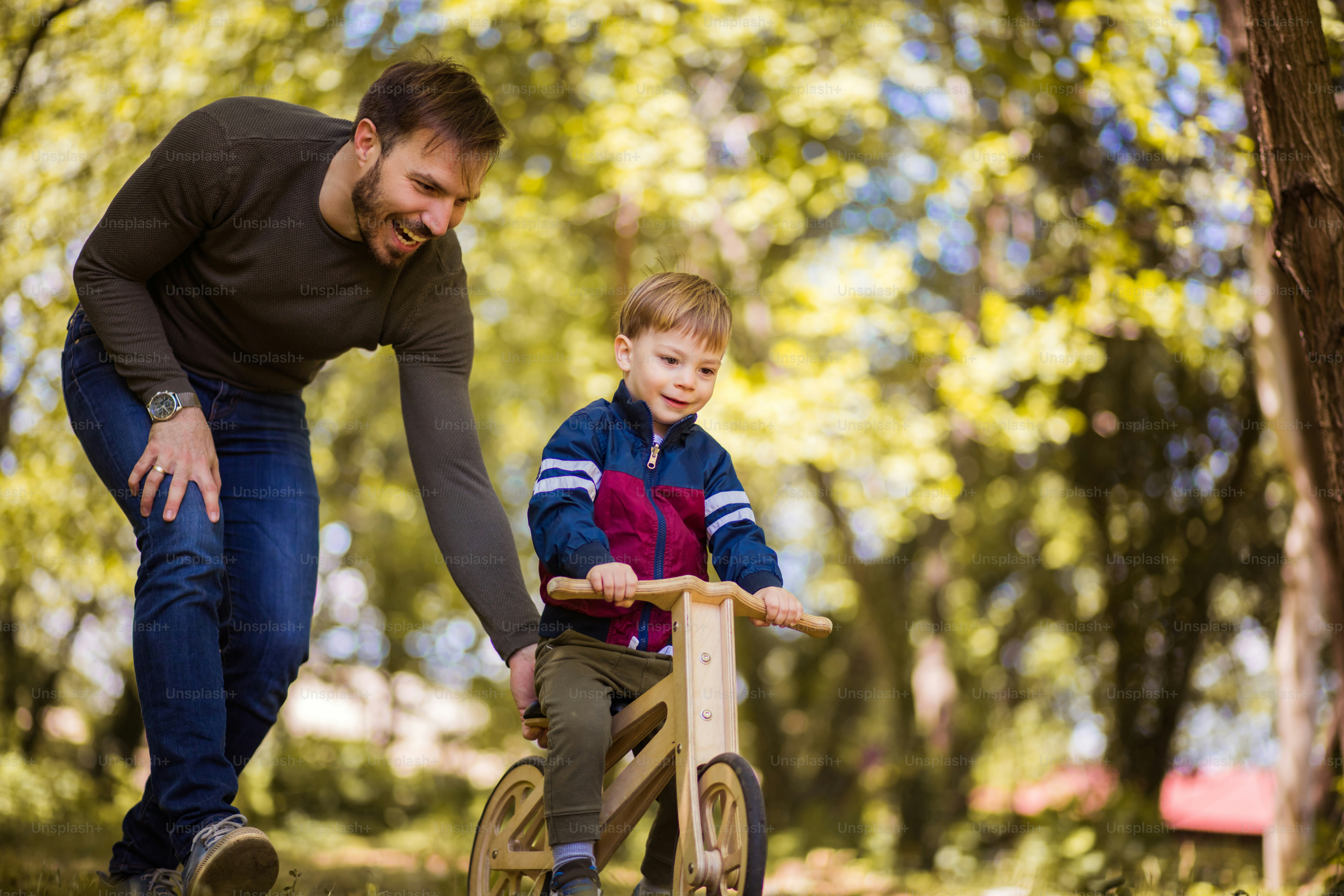 Great bond. Father teaches the son to ride a bicycle.