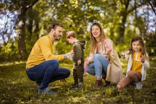 Summer is so much better with family. Parents spending time with their children outside.