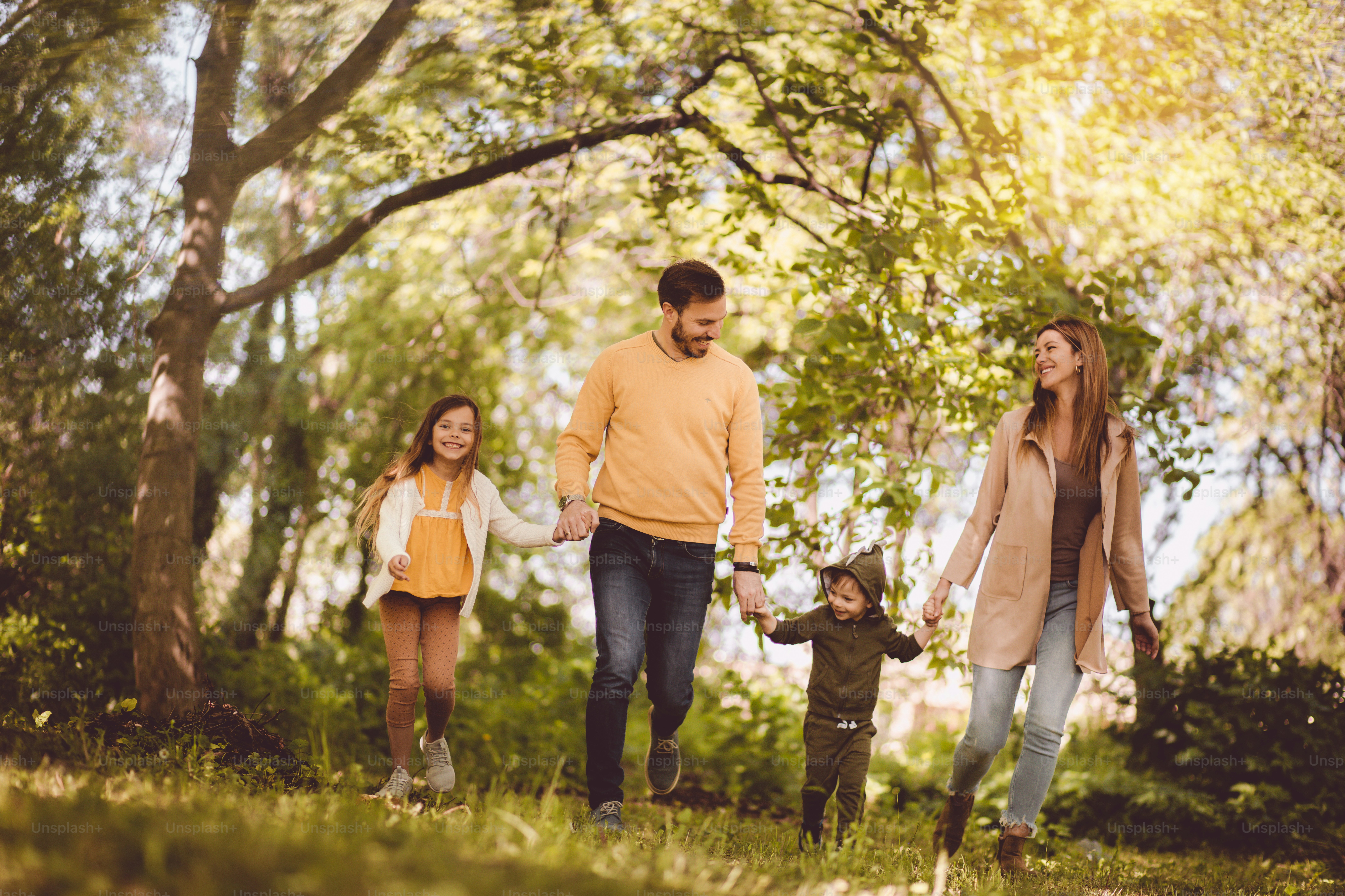 These memories will leave footprints in their hearts forever. Parents spending time with their children outside.