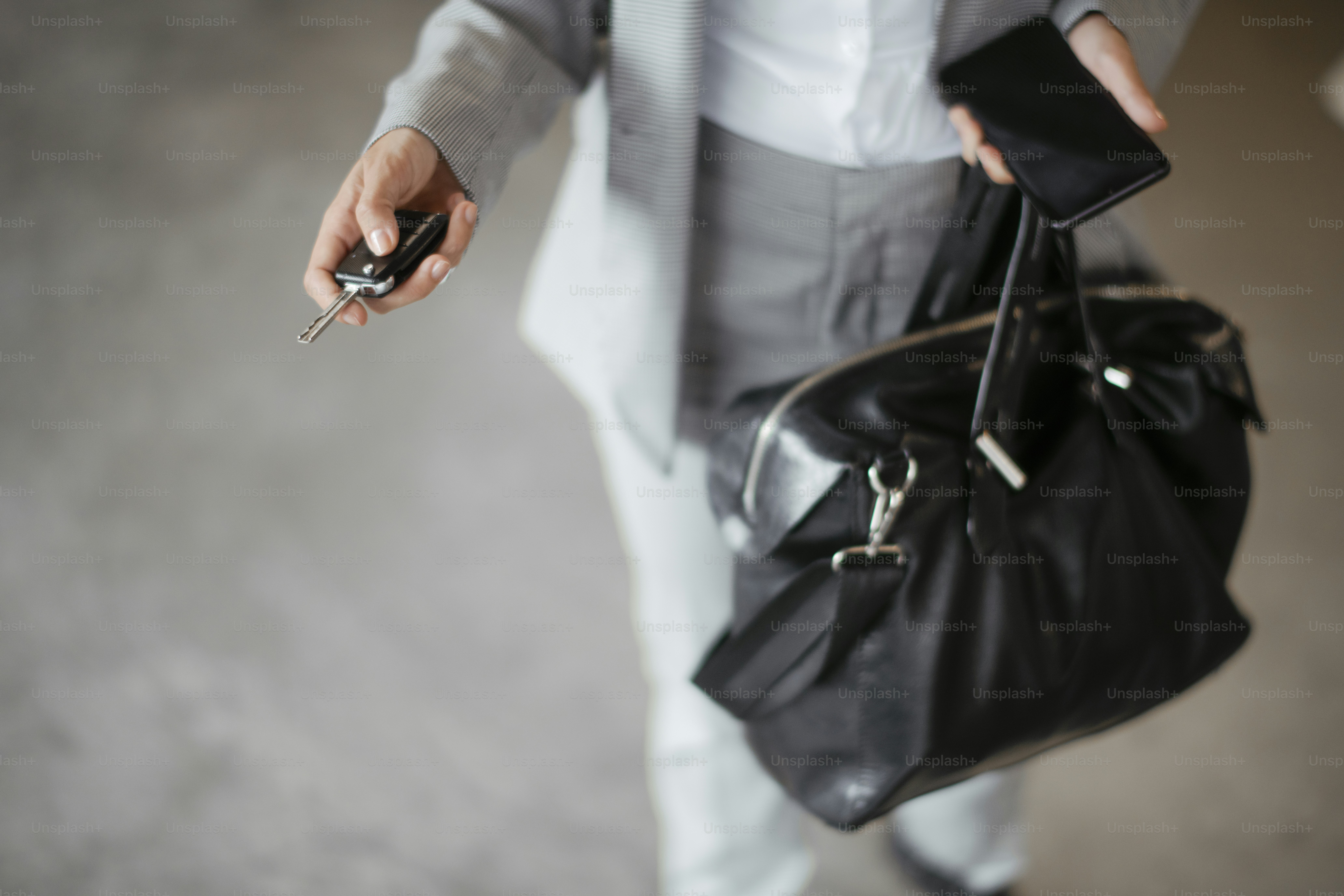 Businesswoman in garage unlocking car