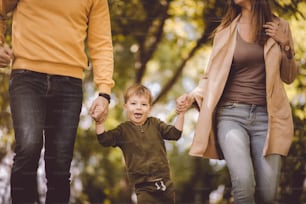 Summer is much better when we spend it together. Parents spending time with  son outside.