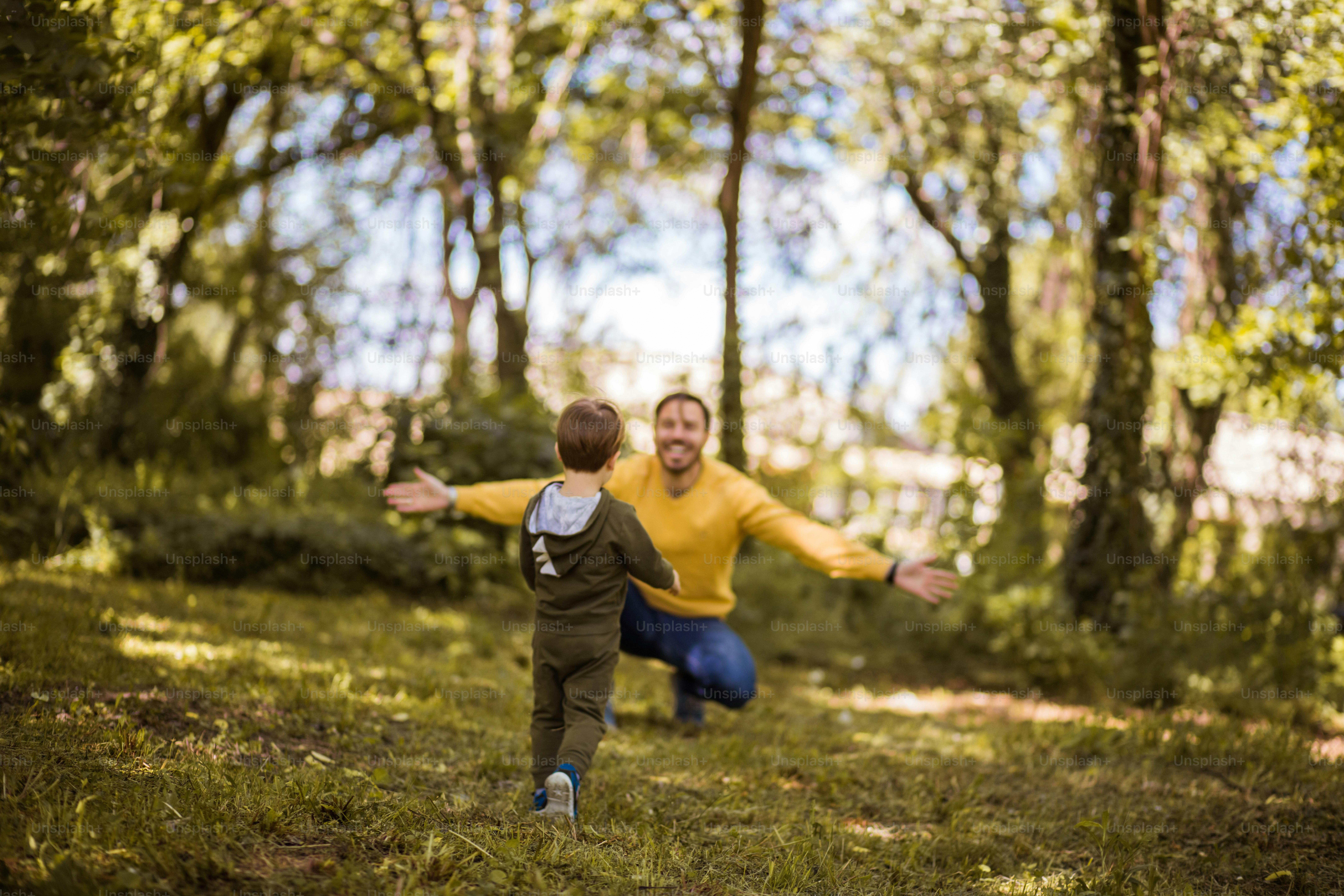 Give me a hug. Father spending time with his son outside.