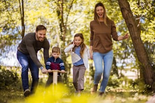 Making time for the family.  Parents spending time with their children outside.