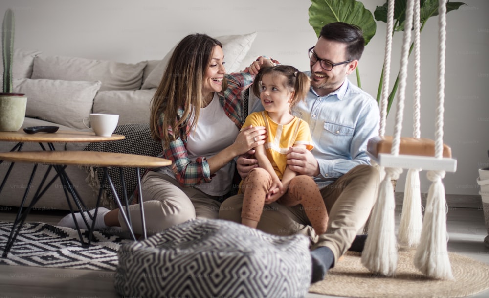 Family is a treasure. Parents with daughter at home.