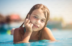 I love summer. Child lying in the pool.