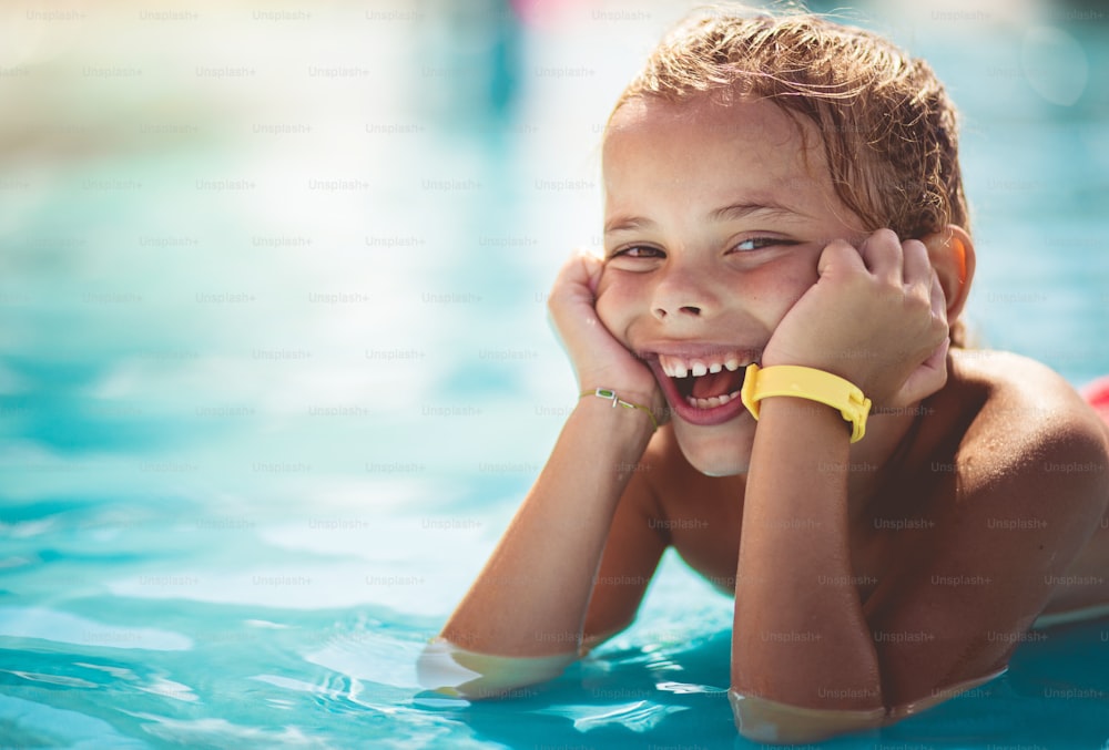 Summer days. Smiling little girl in pool.
