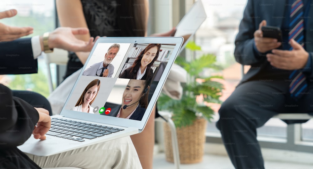 Video call group business people meeting on virtual workplace or remote office. Telework conference call using smart video technology to communicate colleague in professional corporate business.