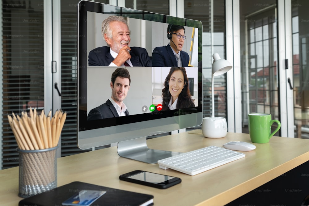 Video call business people meeting on virtual workplace or remote office. Telework conference call using smart video technology to communicate colleague in professional corporate business.