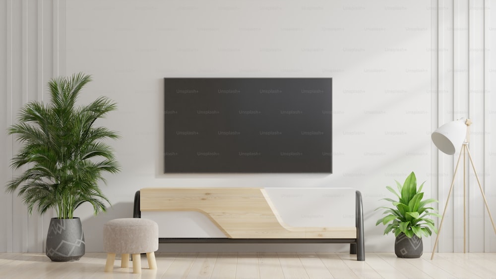 TV sul mobile nel soggiorno moderno con pianta su sfondo bianco della parete, rendering 3d
