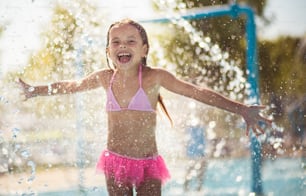 Summer is so great season. Little girl playing in the pool. Looking at camera.