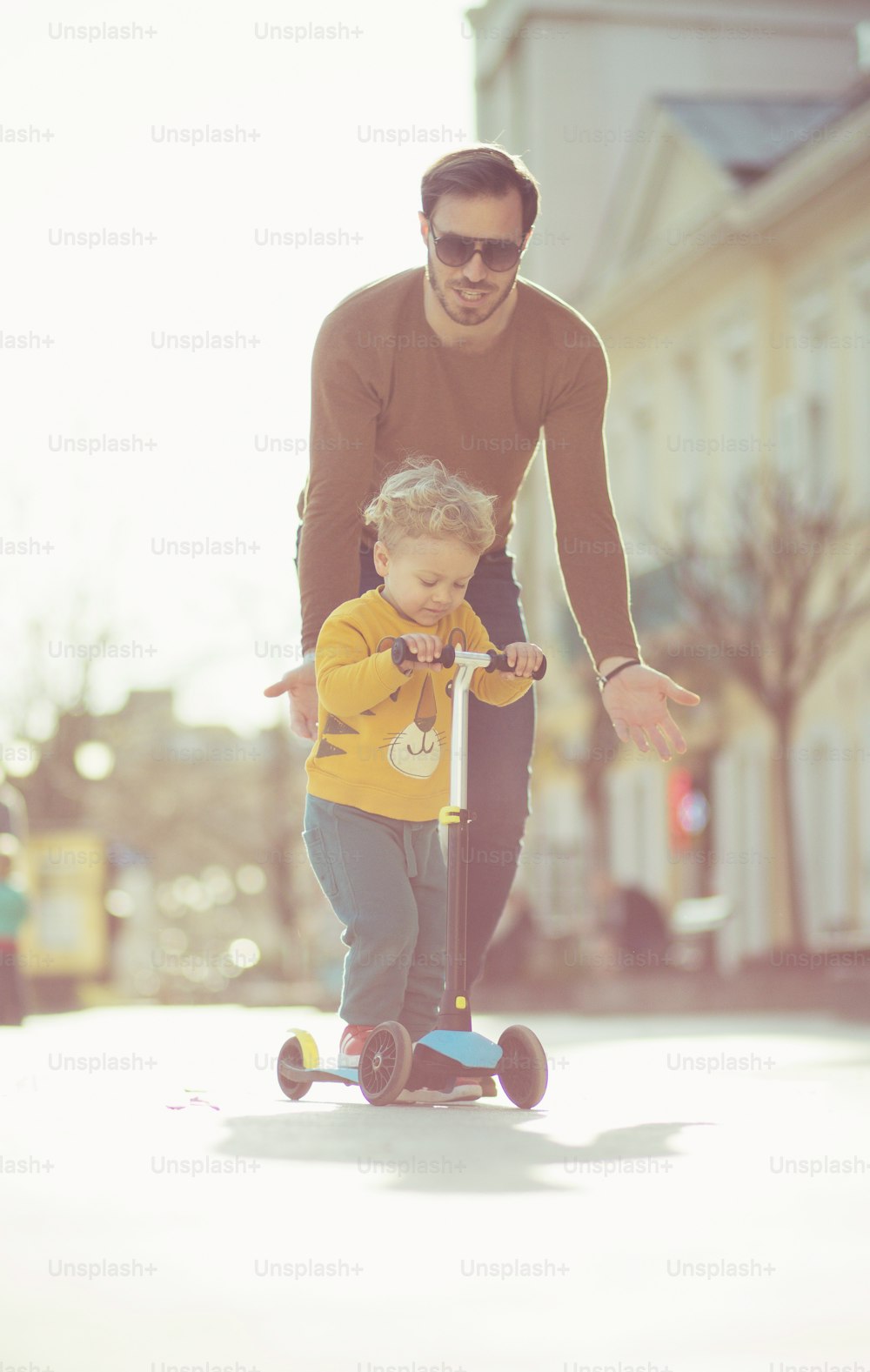 Dad is here to support him. Father and son in the city.