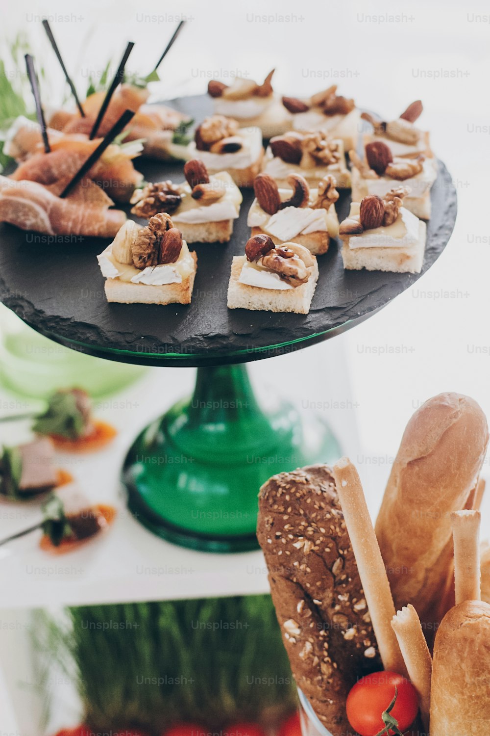 Delicious delicatessen, mediterranean snacks, cheese and olives, appetizers on table at wedding reception in restaurant. Luxury catering service. Christmas table feast.