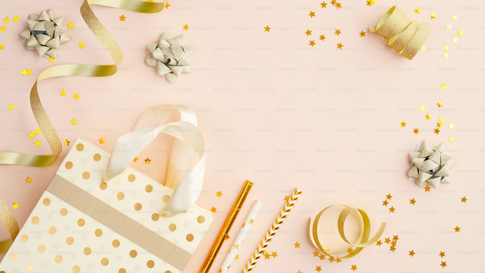 Bag with gifts and party decorations on beige table top view. Birthday sale banner mockup.