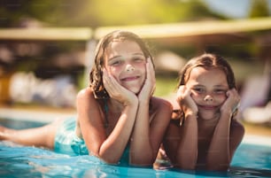 Summer season.  Children lying in pool.