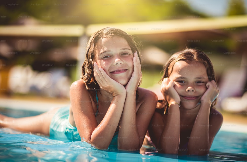 Summer season.  Children lying in pool.