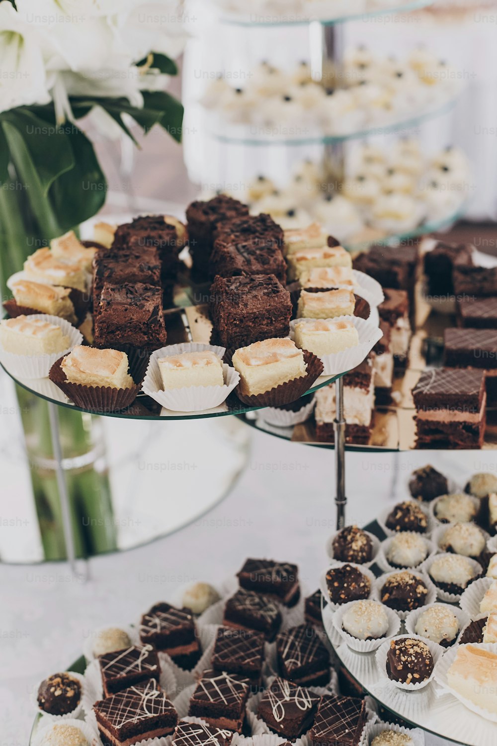 Wedding candy bar. Delicious chocolate desserts, cakes and cookies on stand at wedding reception in restaurant. Luxury catering service