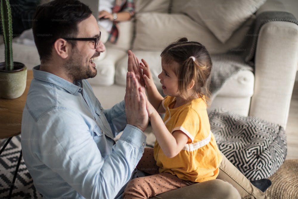 Let's play one fun game. Father playing with her daughter. Focus on foreground.