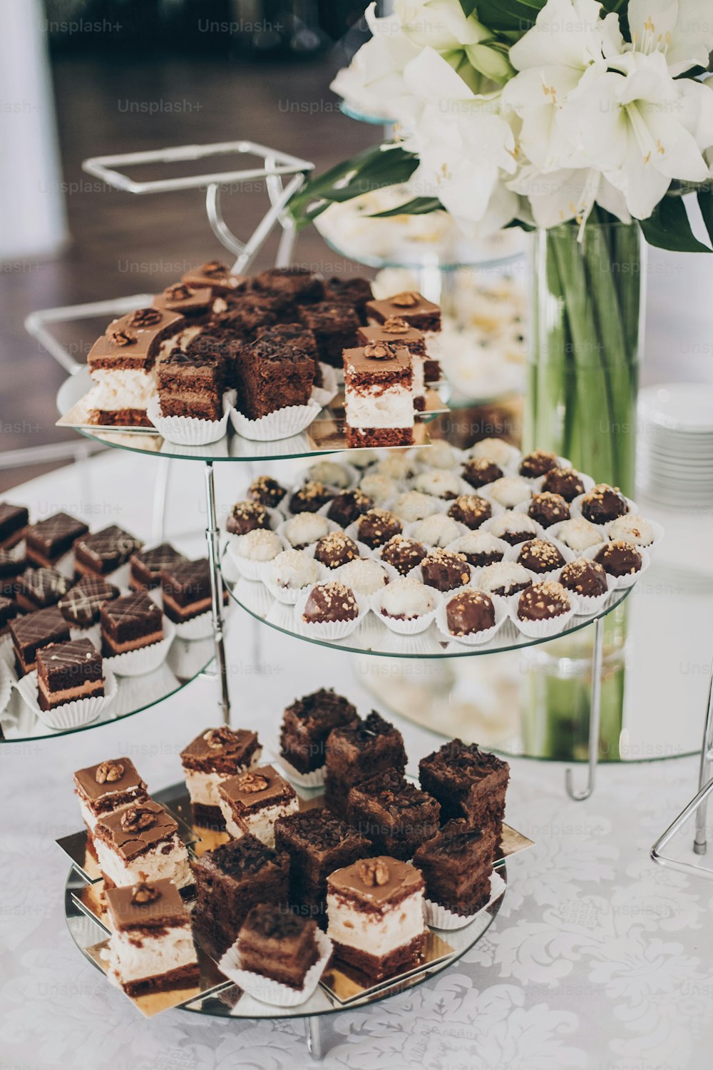 Wedding candy bar. Delicious chocolate desserts, cakes and cookies on stand at wedding reception in restaurant. Luxury catering service