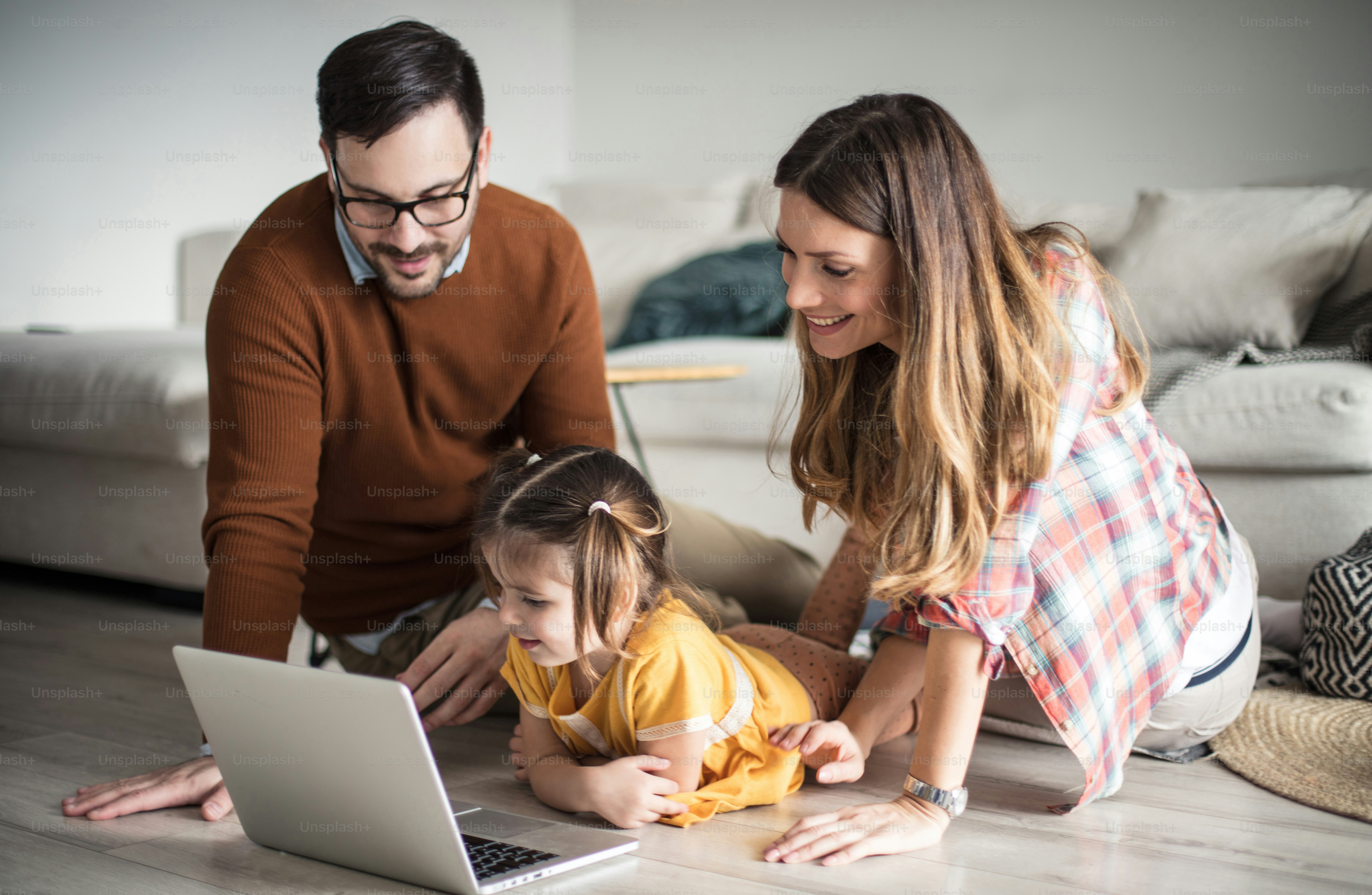Curious to know all about technology. Happy family having fun at home ...