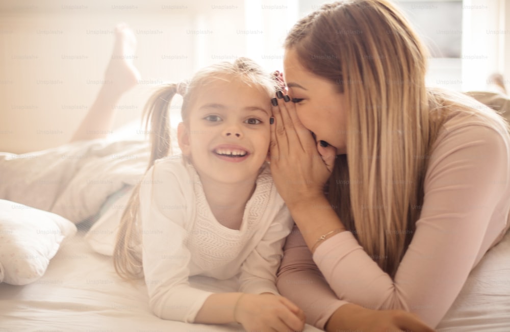 Don't tell anyone. Mother and daughter in bed.