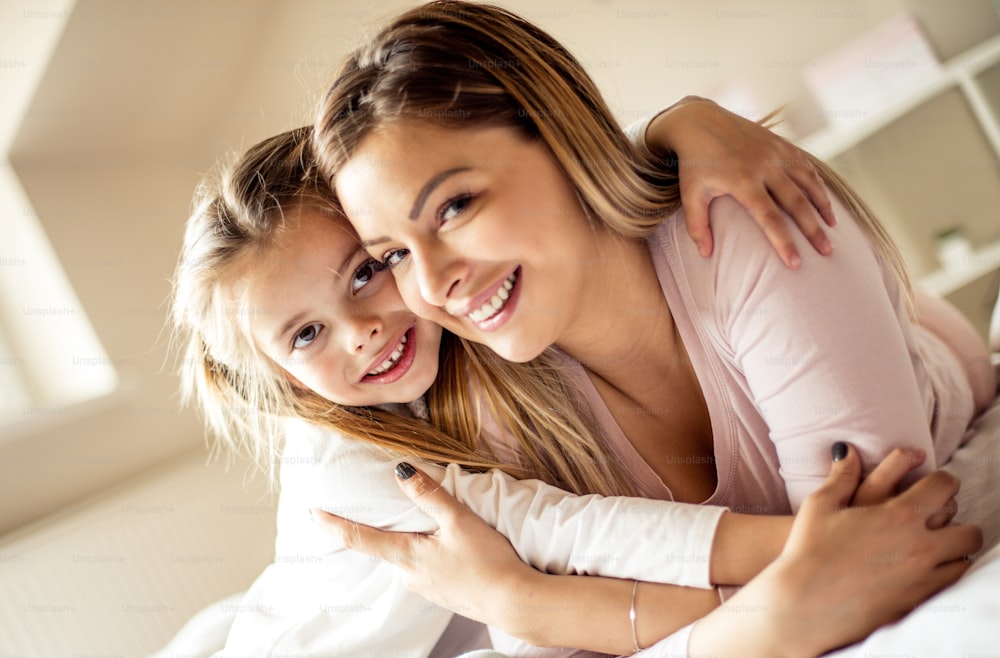 I'll be near you forever. Mother daughter on bed.