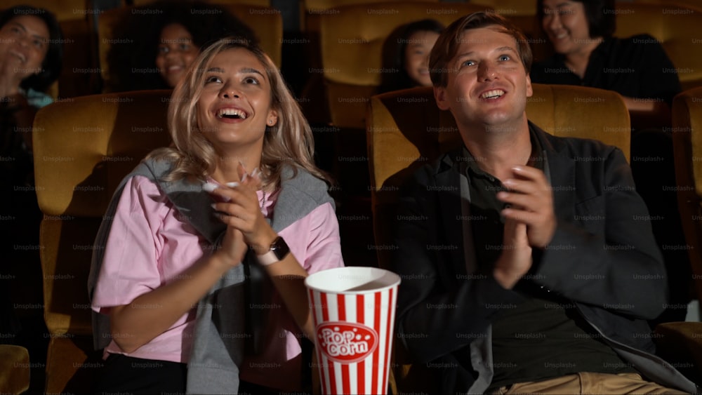 Audience applauding and enjoy at the end of movie and walked out of the cinema