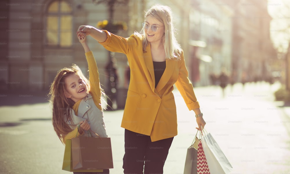 Dansons. Mère et fille faisant du shopping dans la ville.