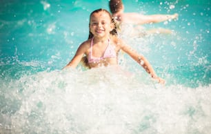 The waves are perfect. Child having fun in the pool.