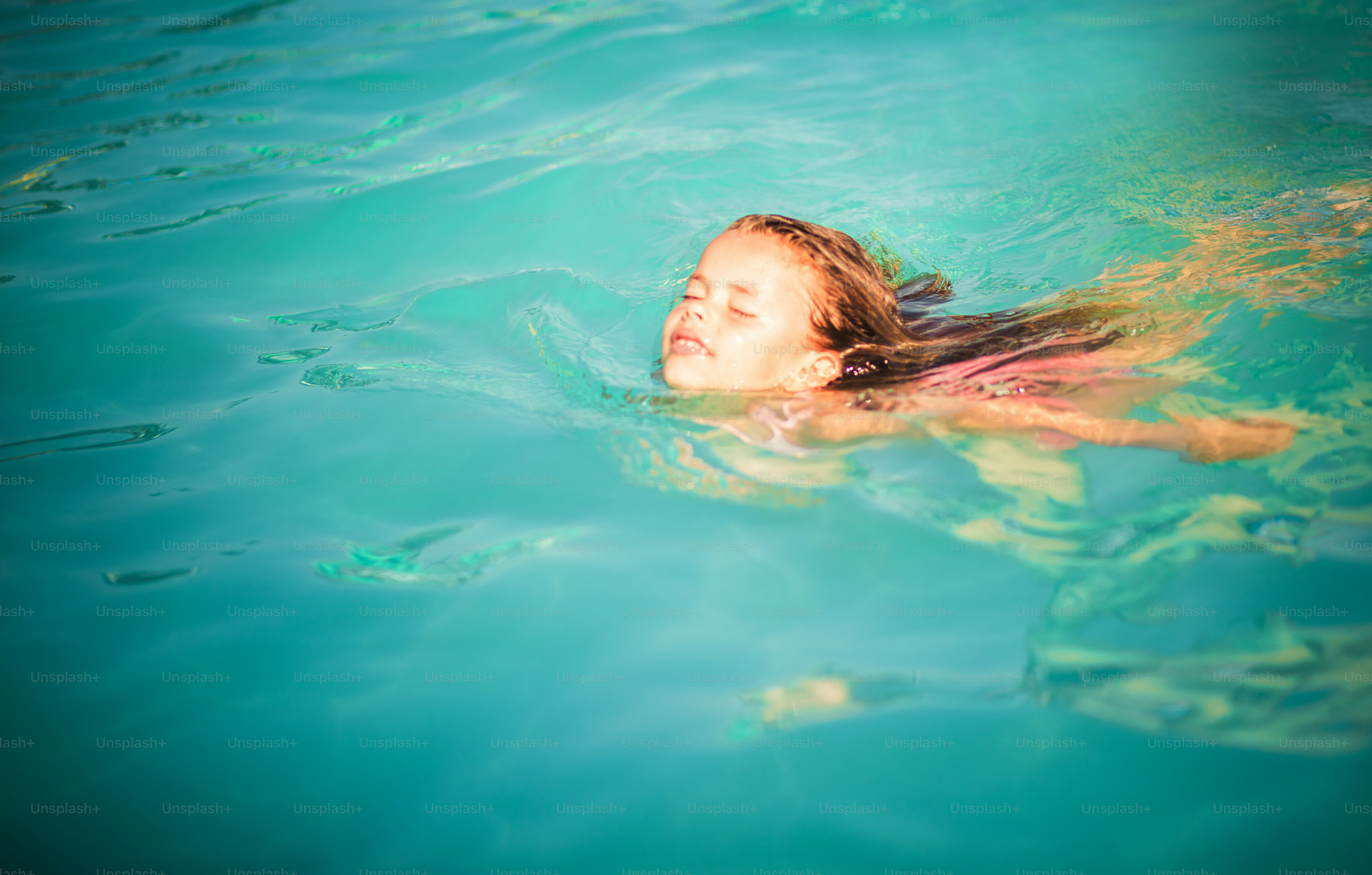 For her swimming is recreation. Child swimming in the pool.