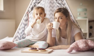 Our breakfast is great. Mother and daughter having breakfast in bed.