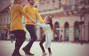 Dancing on street. Family in the city.