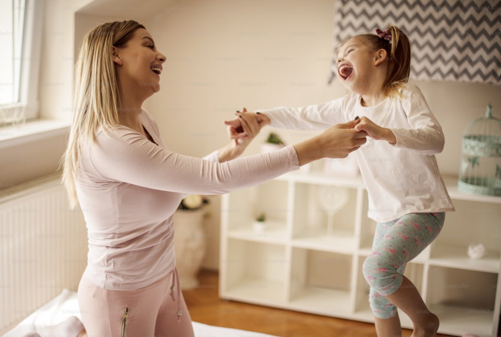 Wild dance. Mother and daughter on bed.