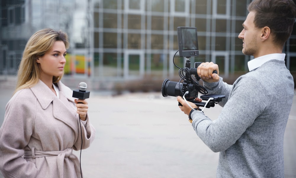 Journalist crew making reportage for the news on a city streets