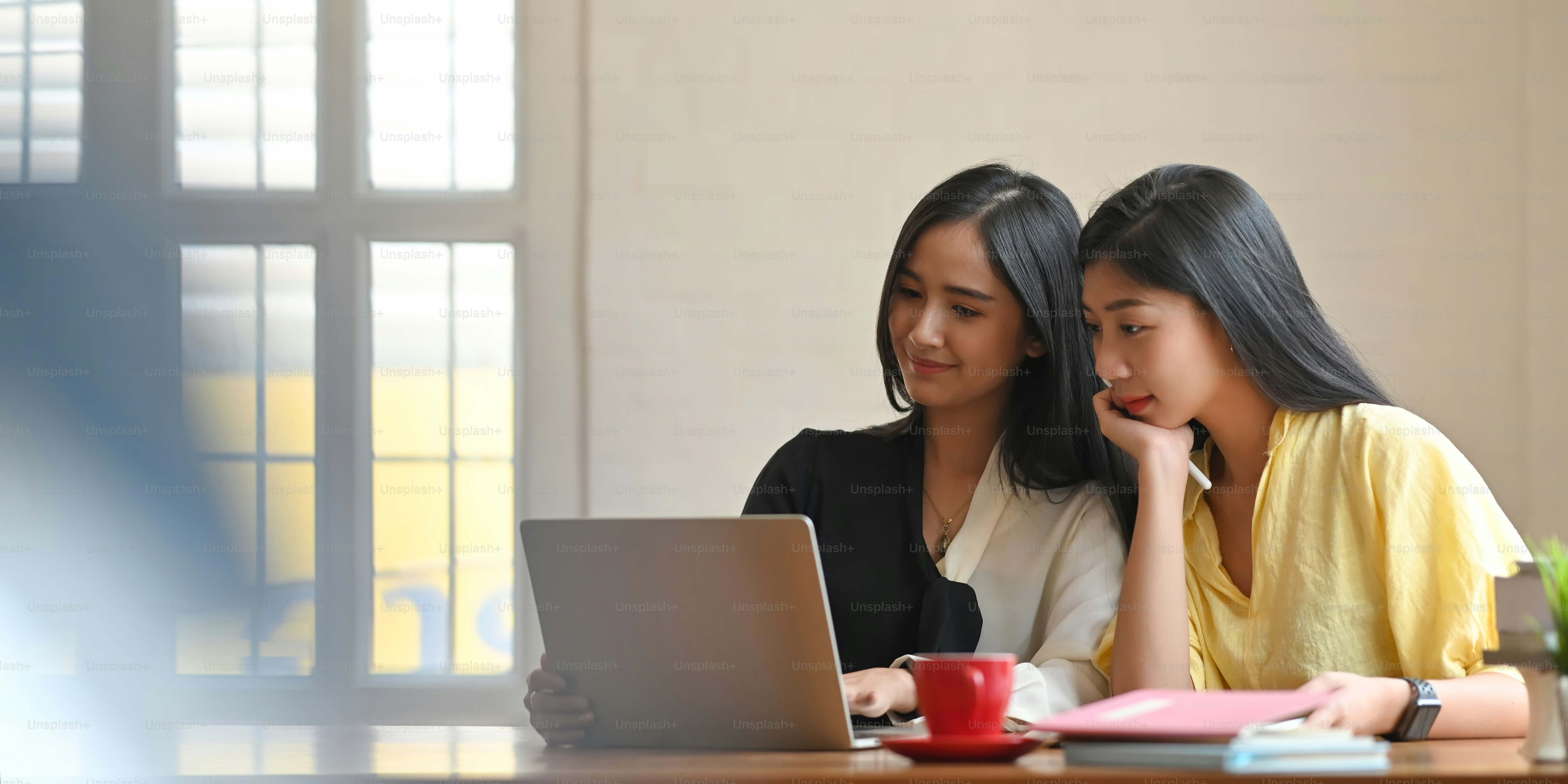 Businesspeople is working together at the wooden table.