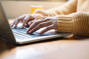 Young woman working or study from home. Close up hand with laptop.