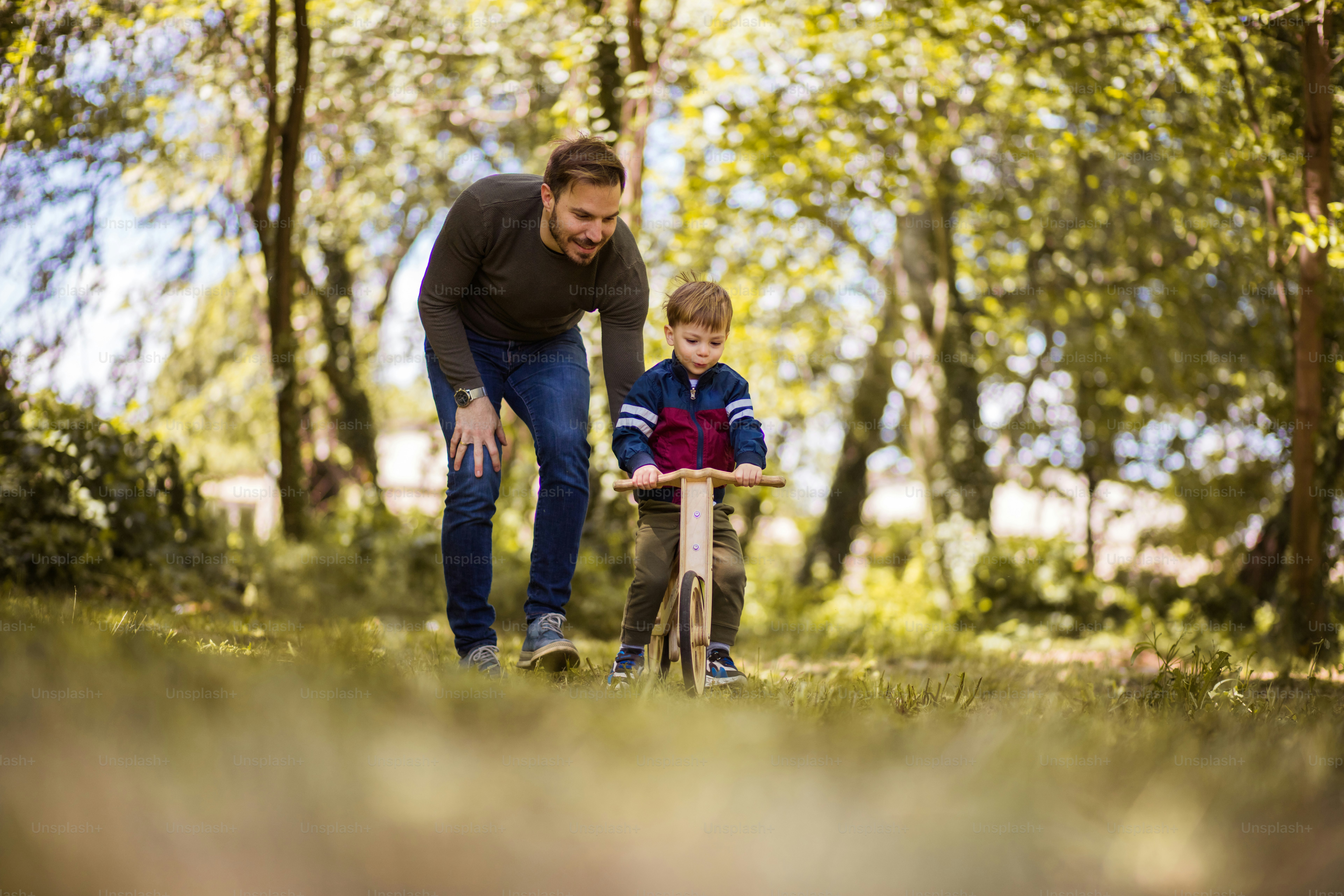 Little things make us happy. Father teaches the son to ride a bicycle.