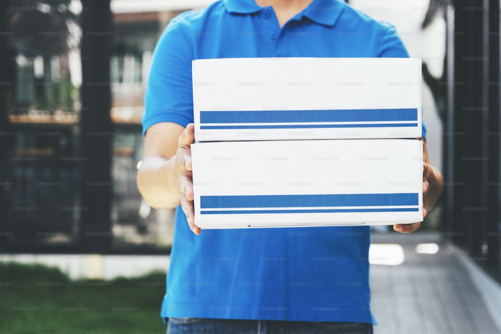 Delivery man holding cardboard boxes. Online shopping and Express delivery.