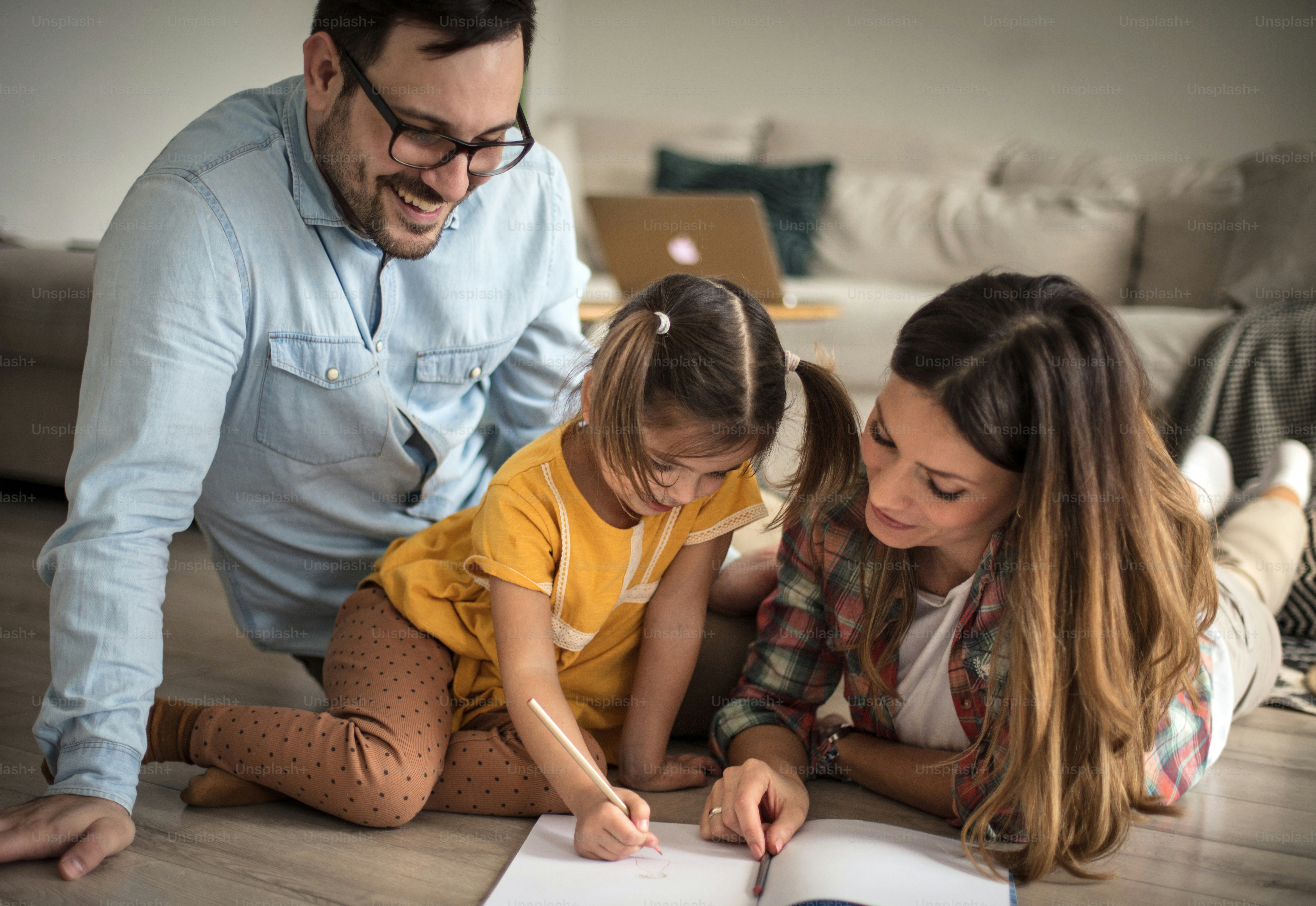 Sometimes need help. Parents help their daughter with homework. photo ...