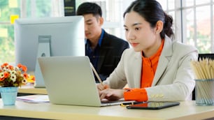 Business people working at table in modern office room while analyzing financial data report .