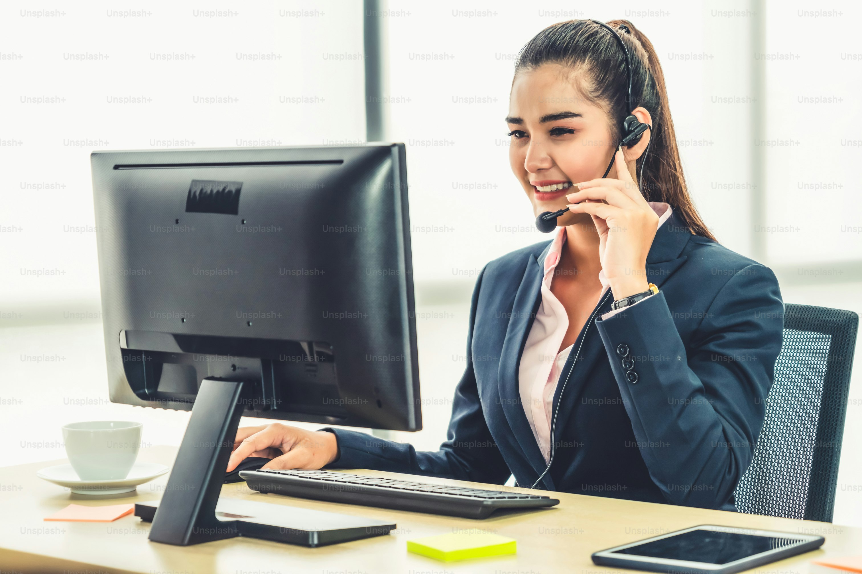 Business people wearing headset working in office to support remote customer or colleague. Call center, telemarketing, customer support agent provide service on telephone video conference call.