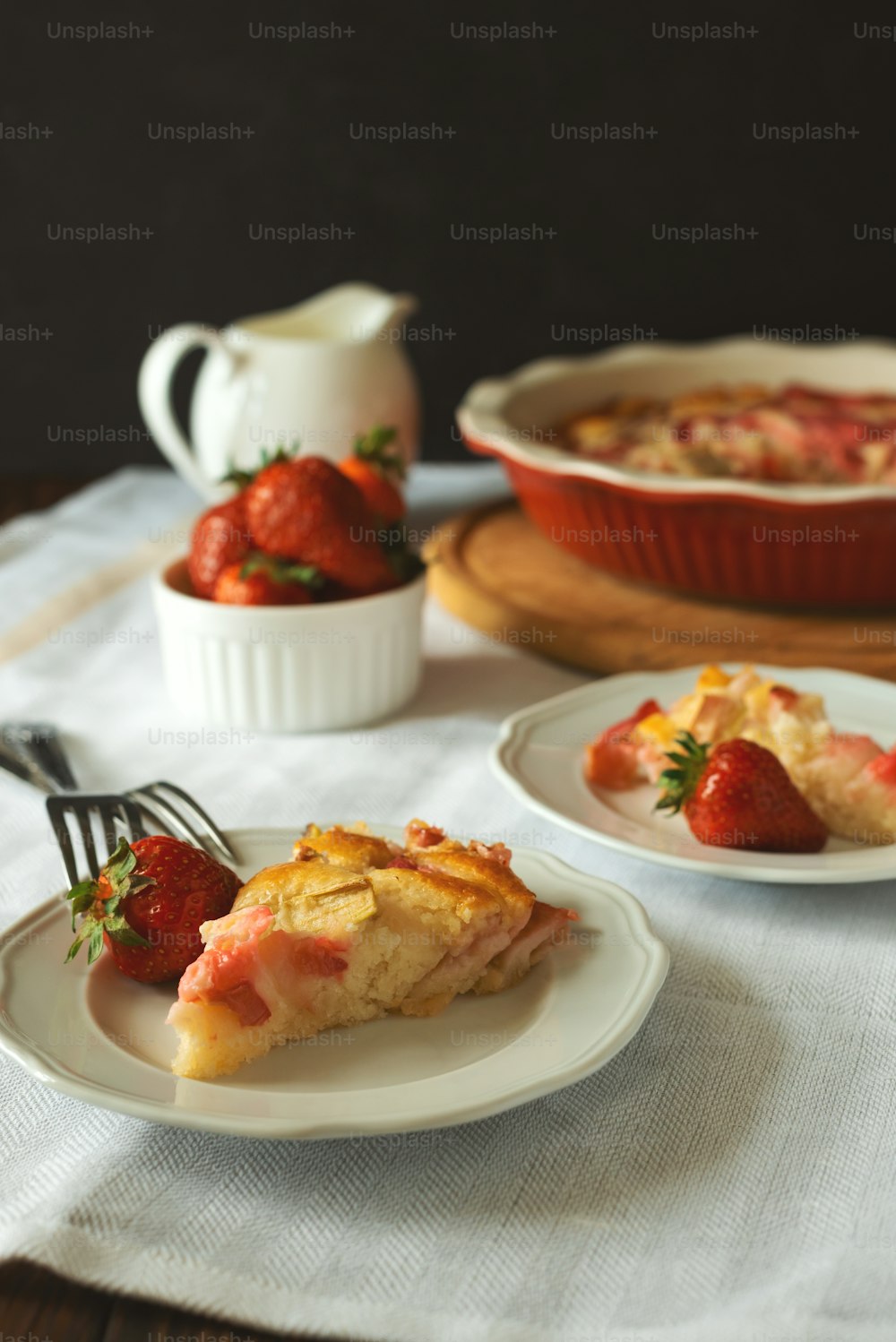 Morceau de tarte aux fraises fraîches et à la rhubarbe dans une assiette. Manger de la nourriture d’été
