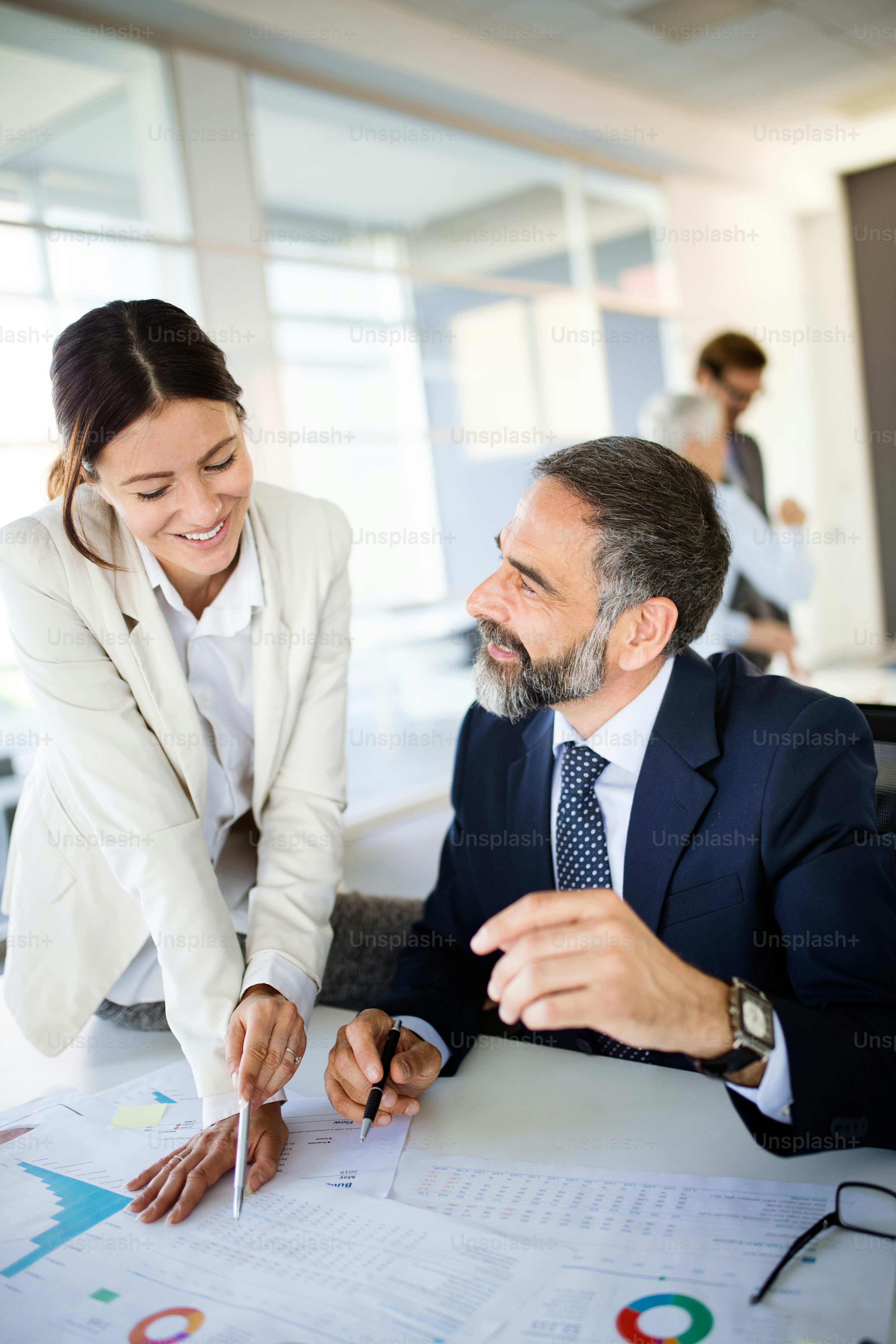 Collaboration and analysis by business people working in modern office